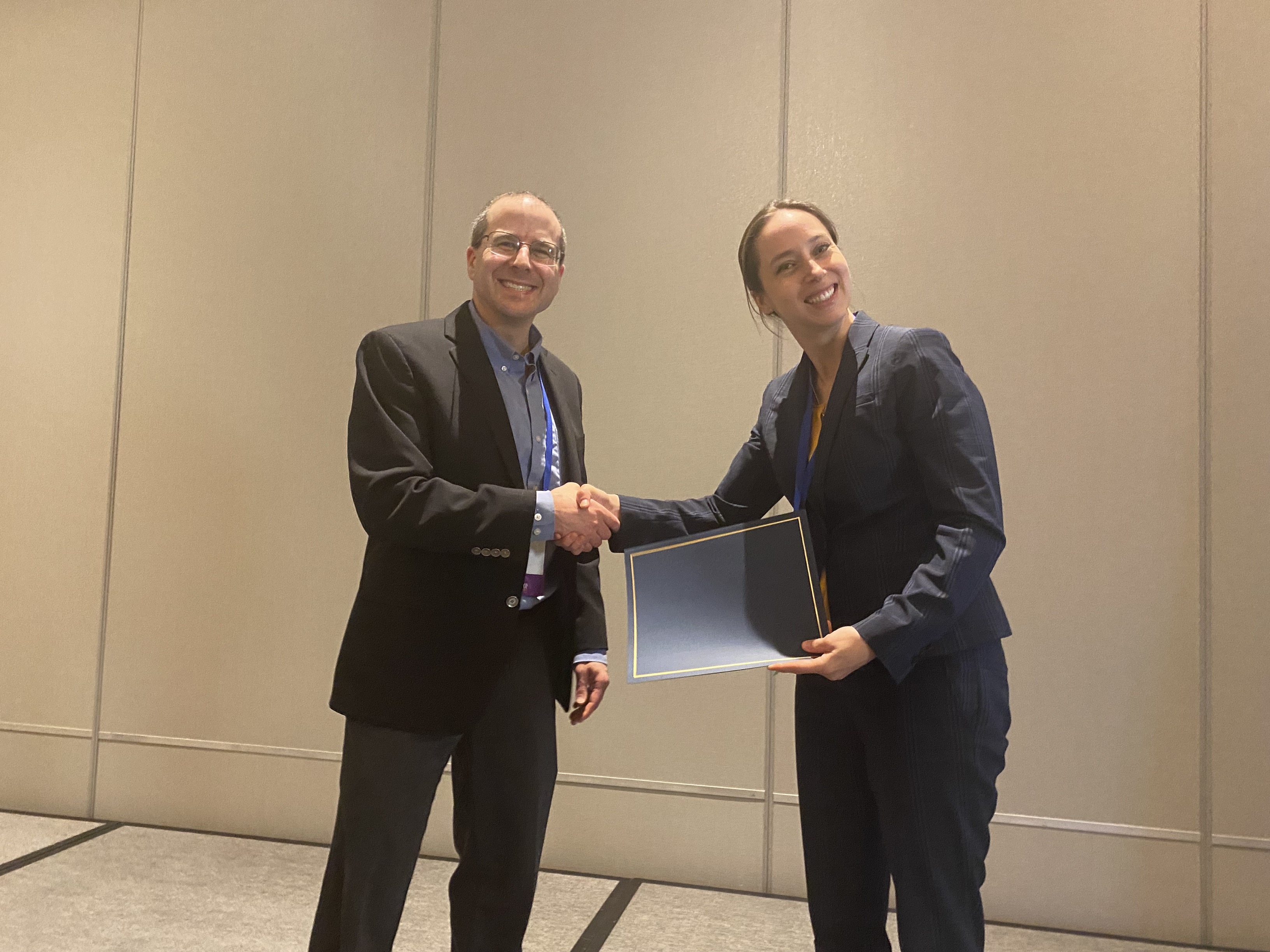 Dr. Sara McCoy accepting the Foundation's Outstanding Abstract Award on behalf of Maxwell Parker