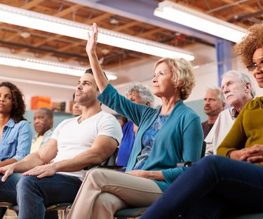 Woman asking question in neighborhood meeting